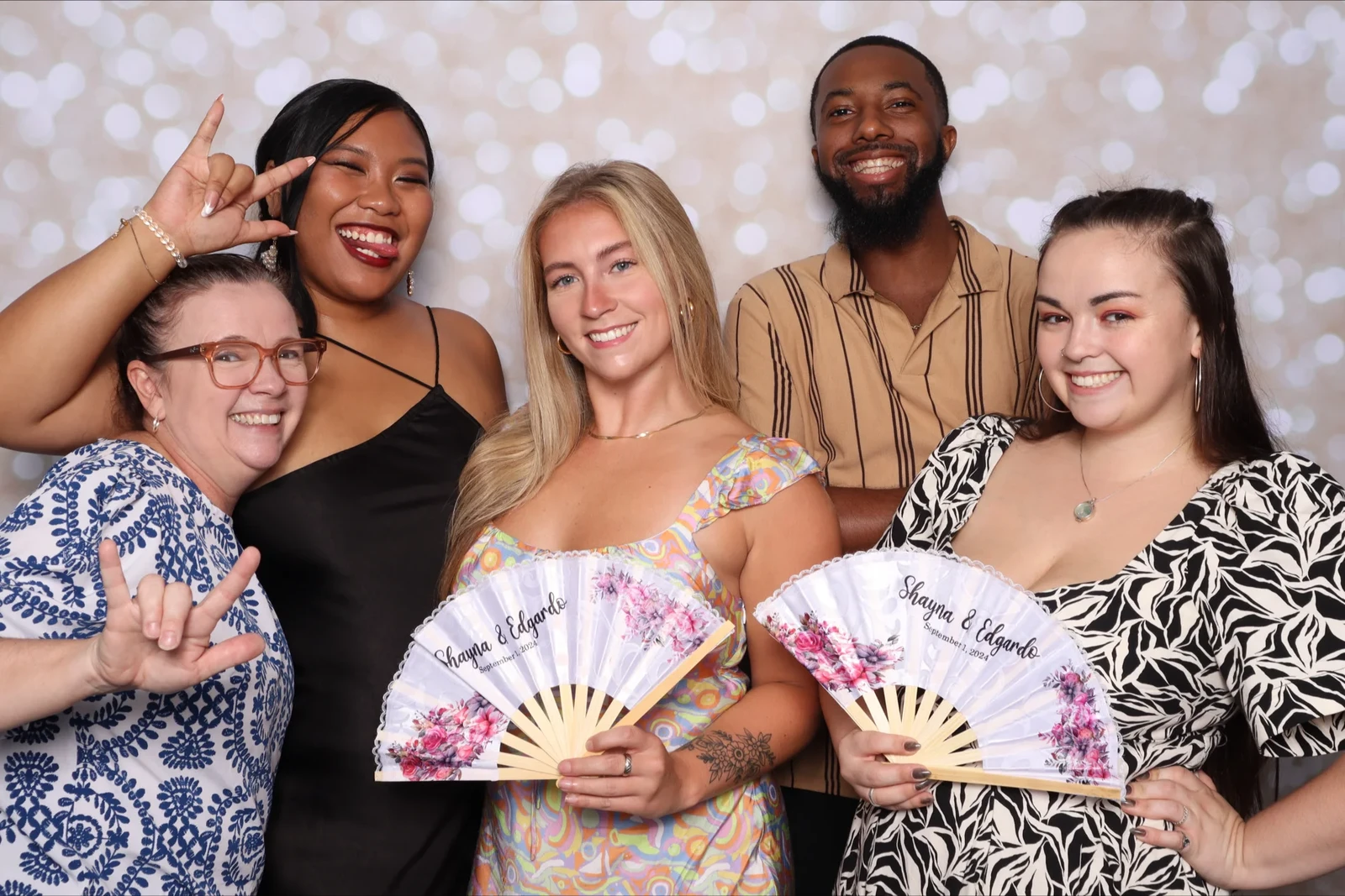 Shayna and Edgardo wedding guests photo booth Virginia Beach 2024 — floral fans